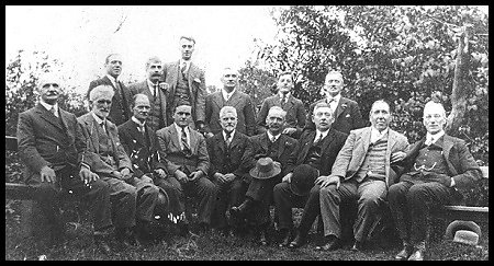 Herbert John, seated front row second from the left, in his later years.  His son Reginald is seated fourth from the left.